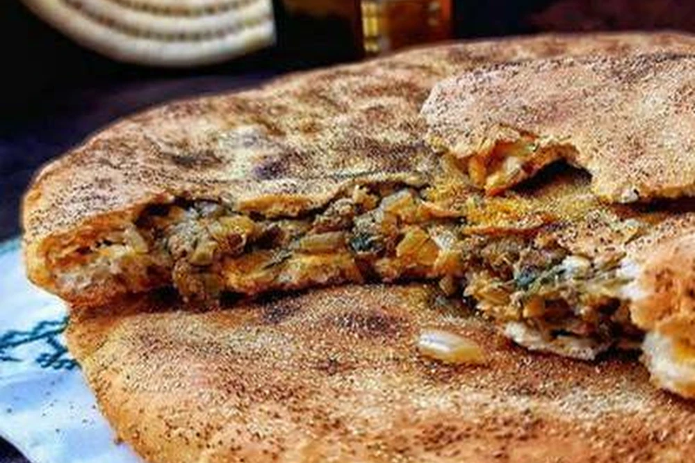Madfouna stuffed bread being prepared in the Merzouga region